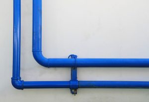 Blue pipes on a concrete wall