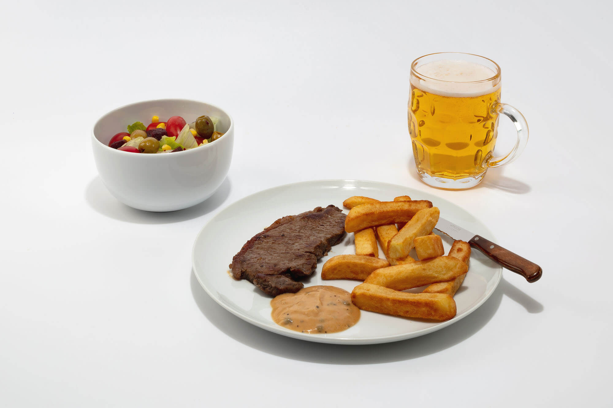 steak dinner with beer and olives